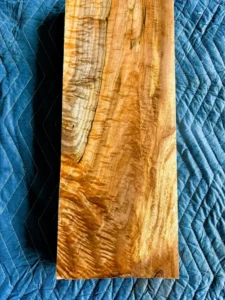 Back side of cut section of maple board with dramatic curl and shimmer