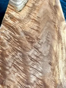 Tight shot of the back side of maple board with dramatic curl and shimmer