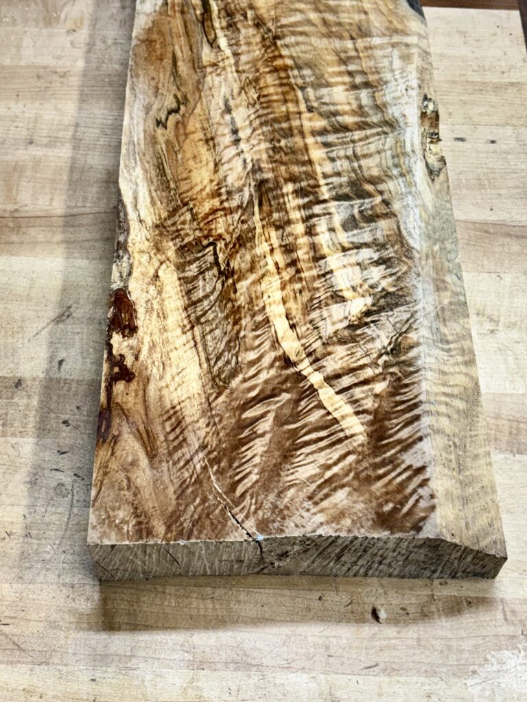 Highly figured curly maple slab prepared for book-matched veneer slicing.