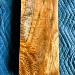 Back side of cut section of maple board with dramatic curl and shimmer