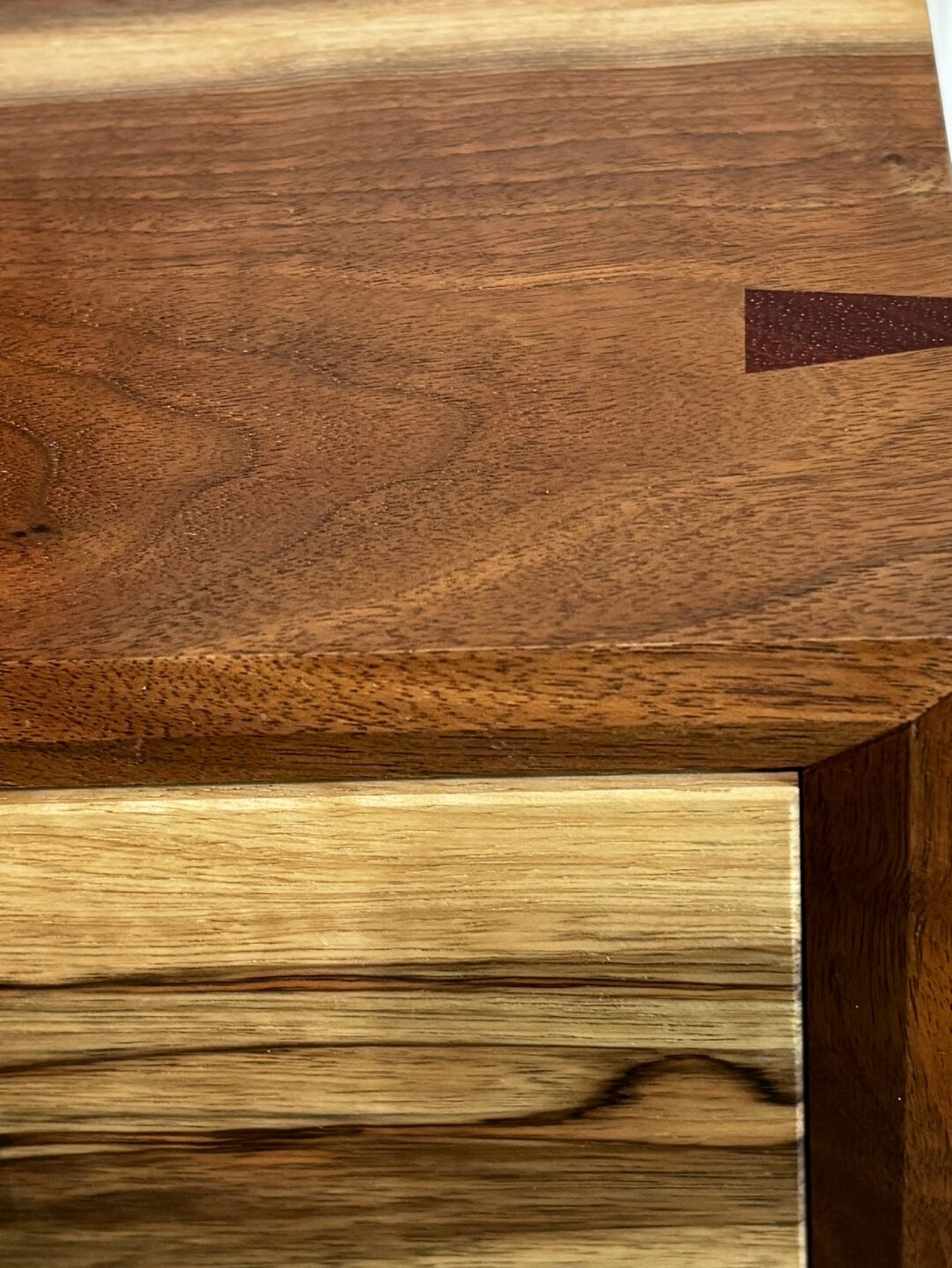 Custom solid walnut cabinet with visible joinery and natural grain pattern